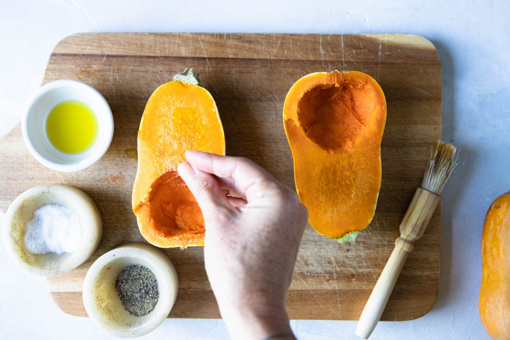 honeynut squash cut in half and sprinkled with salt and pepper