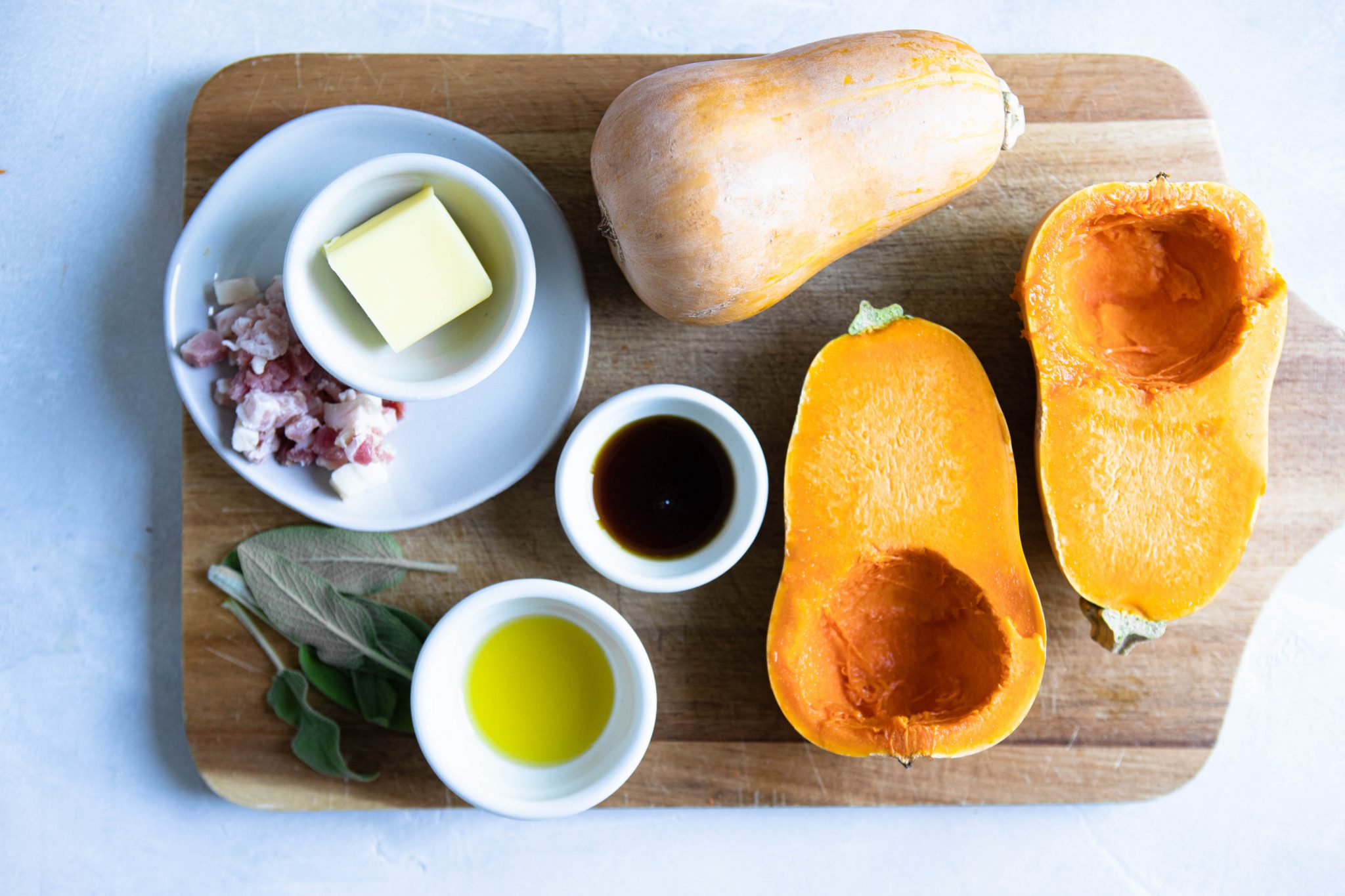 ingredients for oven baked squash dish on a wooden cutting board