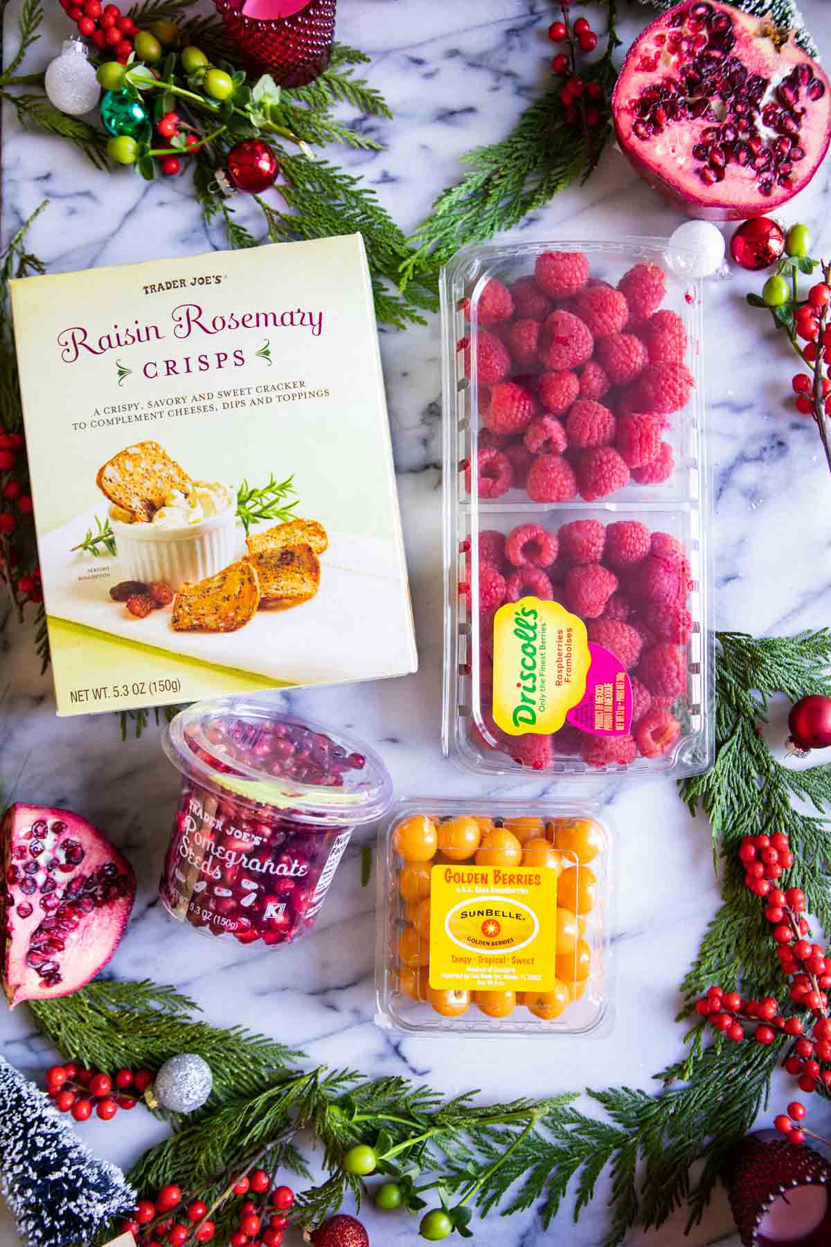 fresh fruit and crackers from Trader Joe's on a marble board to make a grazing board