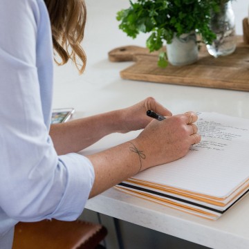 woman writing in a journal