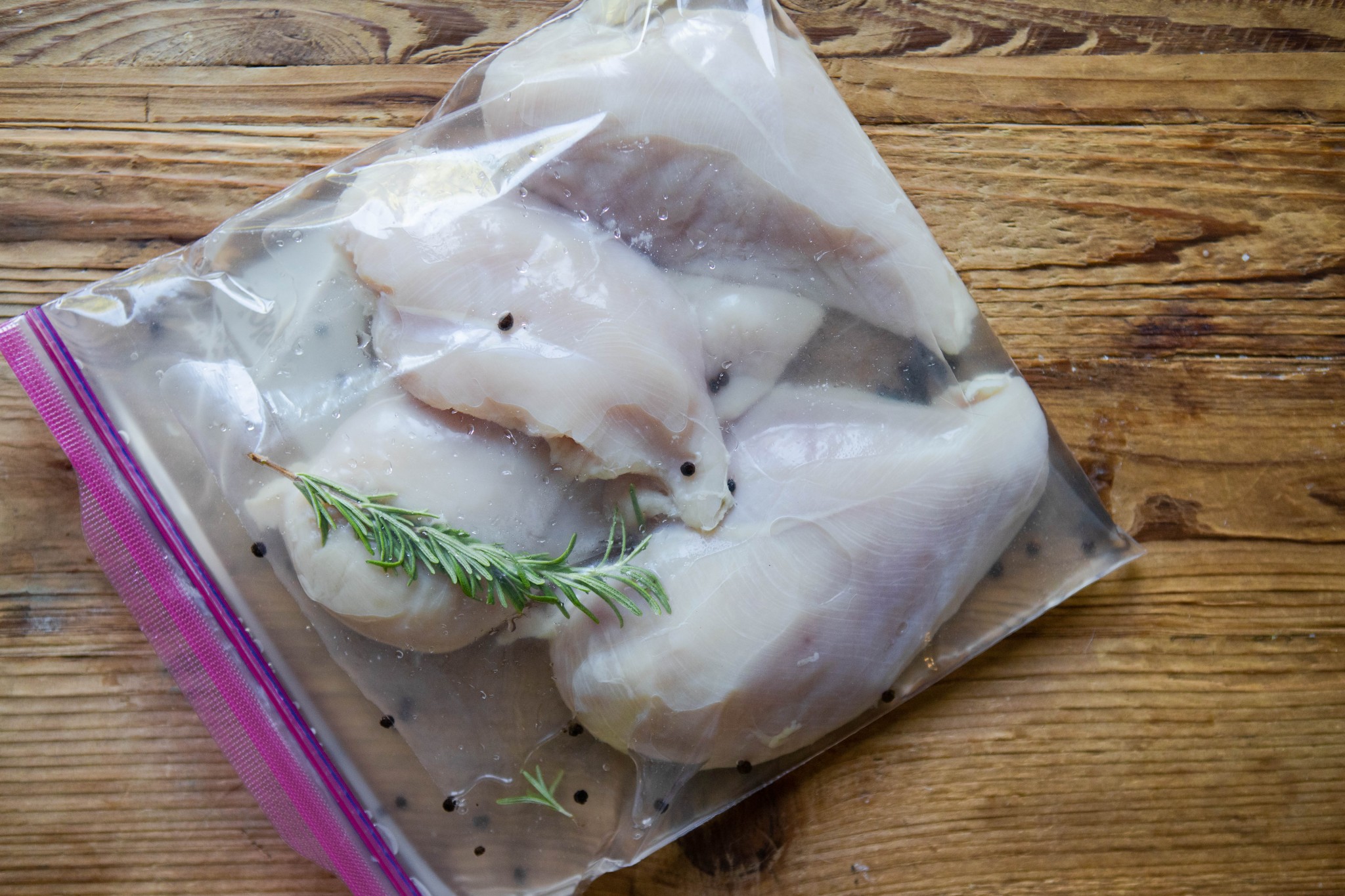 chicken breasts soaking in a a basic salt brine in a Ziploc bag