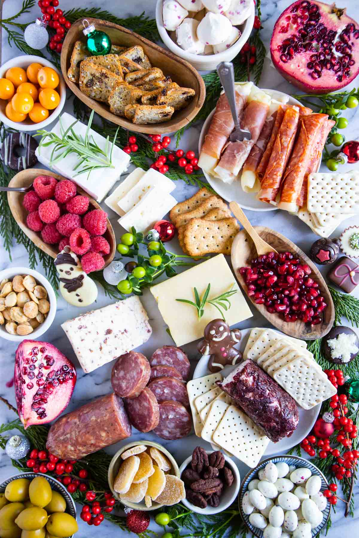 finishing red and green decorative items added to a Christmas charcuterie board