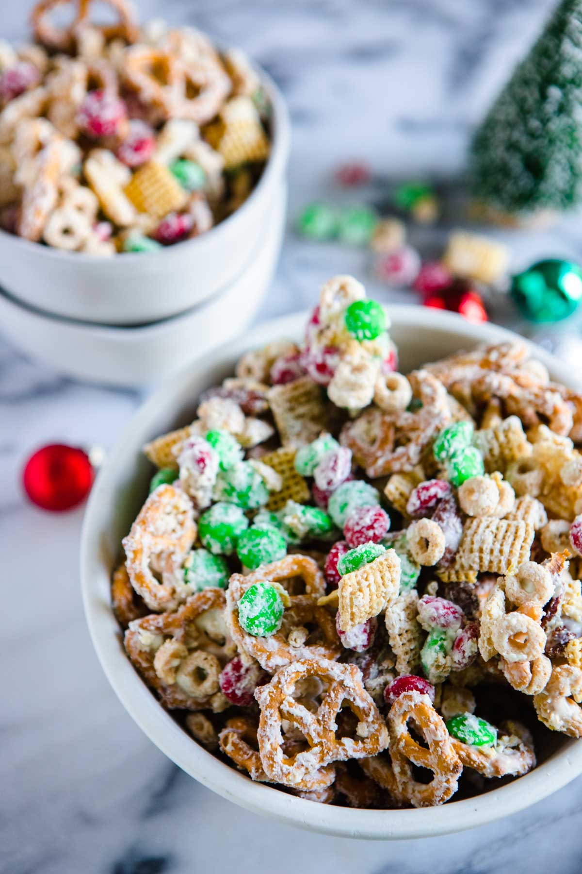 holiday chex mix in a white bowl 