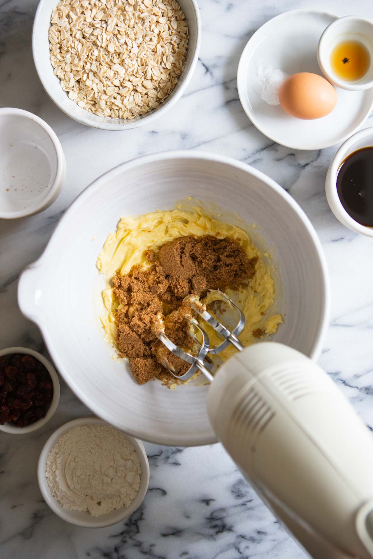 brown sugar being beaten into creamed butter to make cookies 