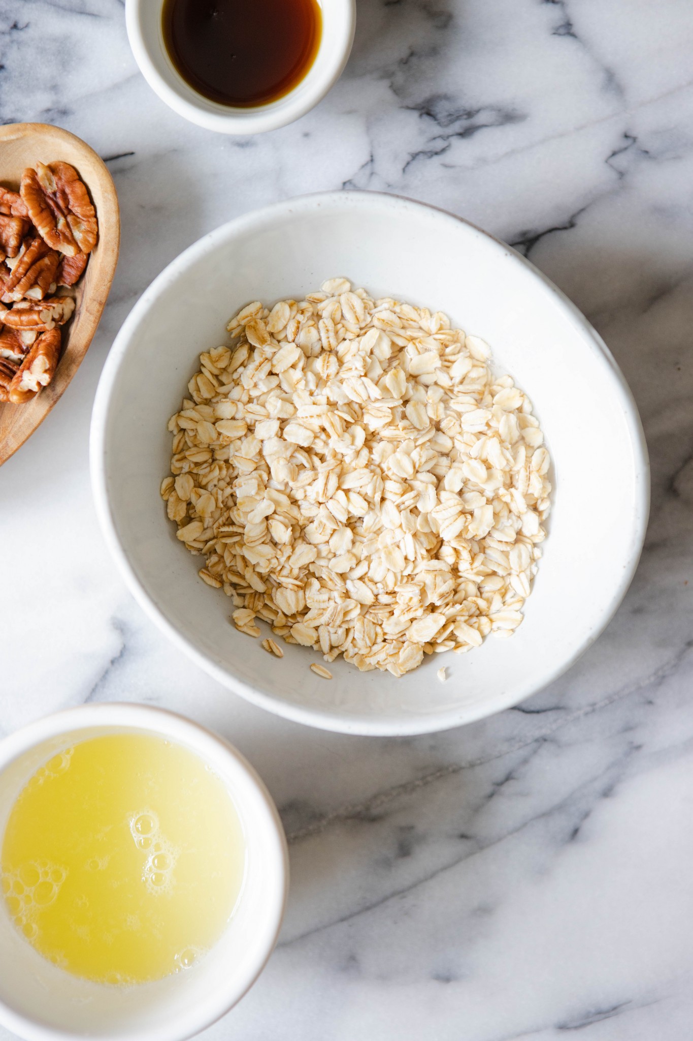 oatmeal and water in a white bowl on marble surface