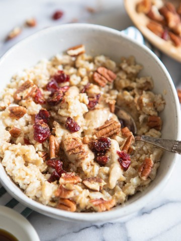 high protein egg white oatmeal with toppings in a white bowl
