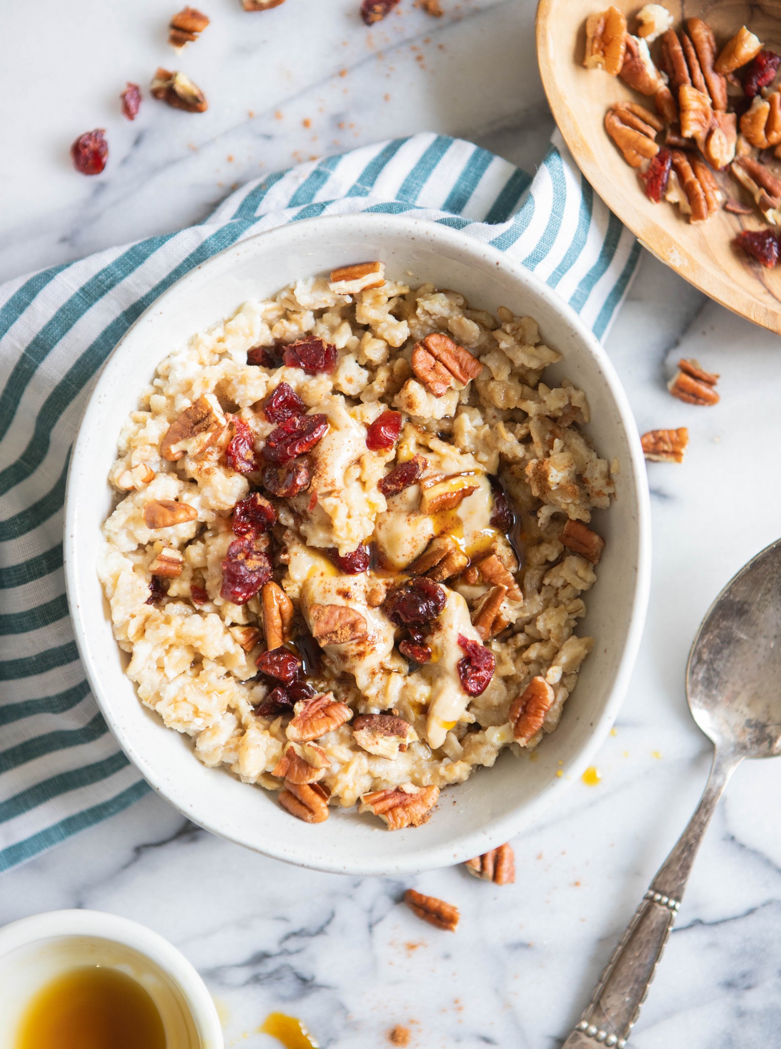 white bowl filled with high protein oatmeal with toppings and a spoon