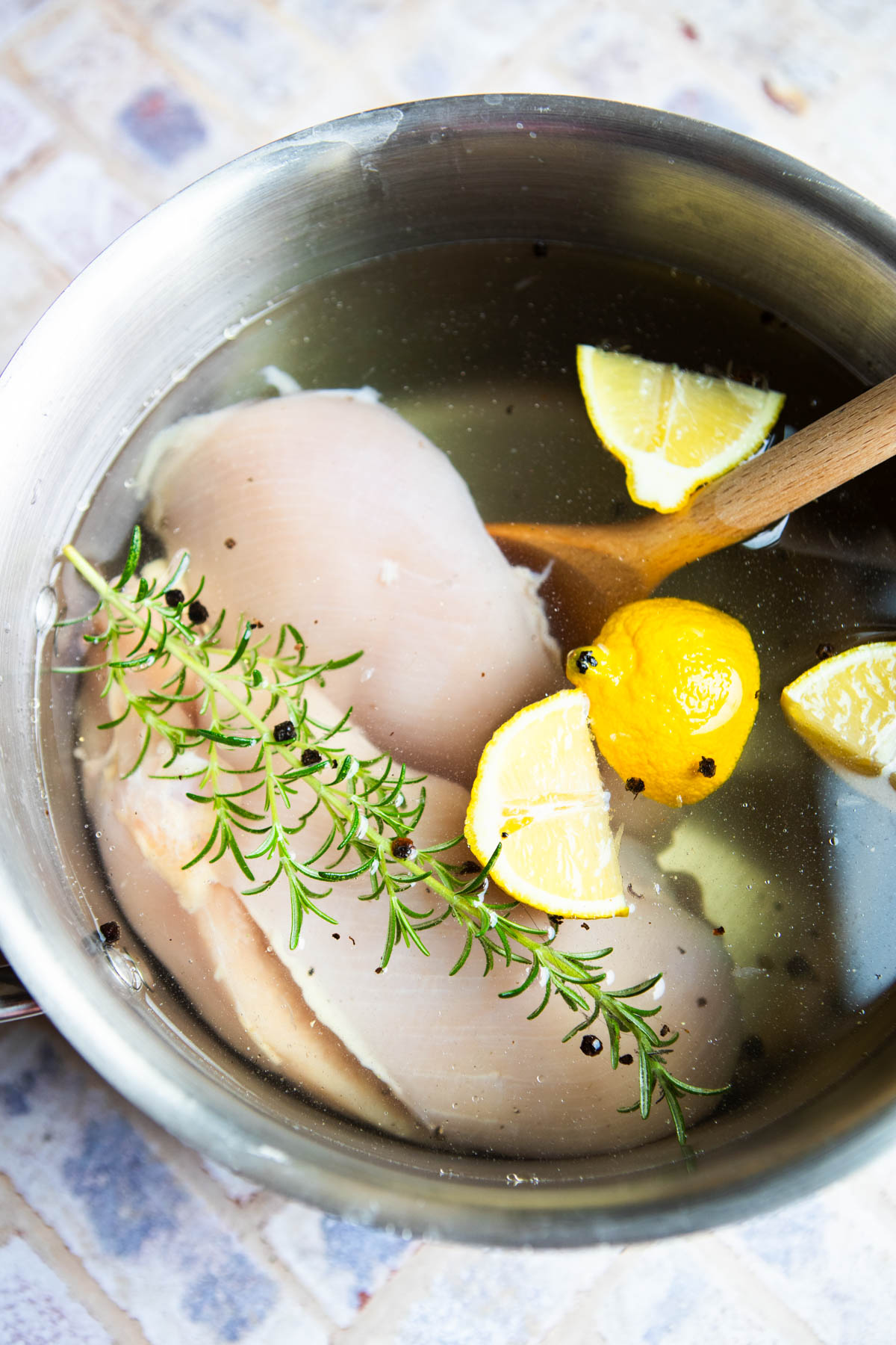 stockpot with chicken breasts in a salt water brine
