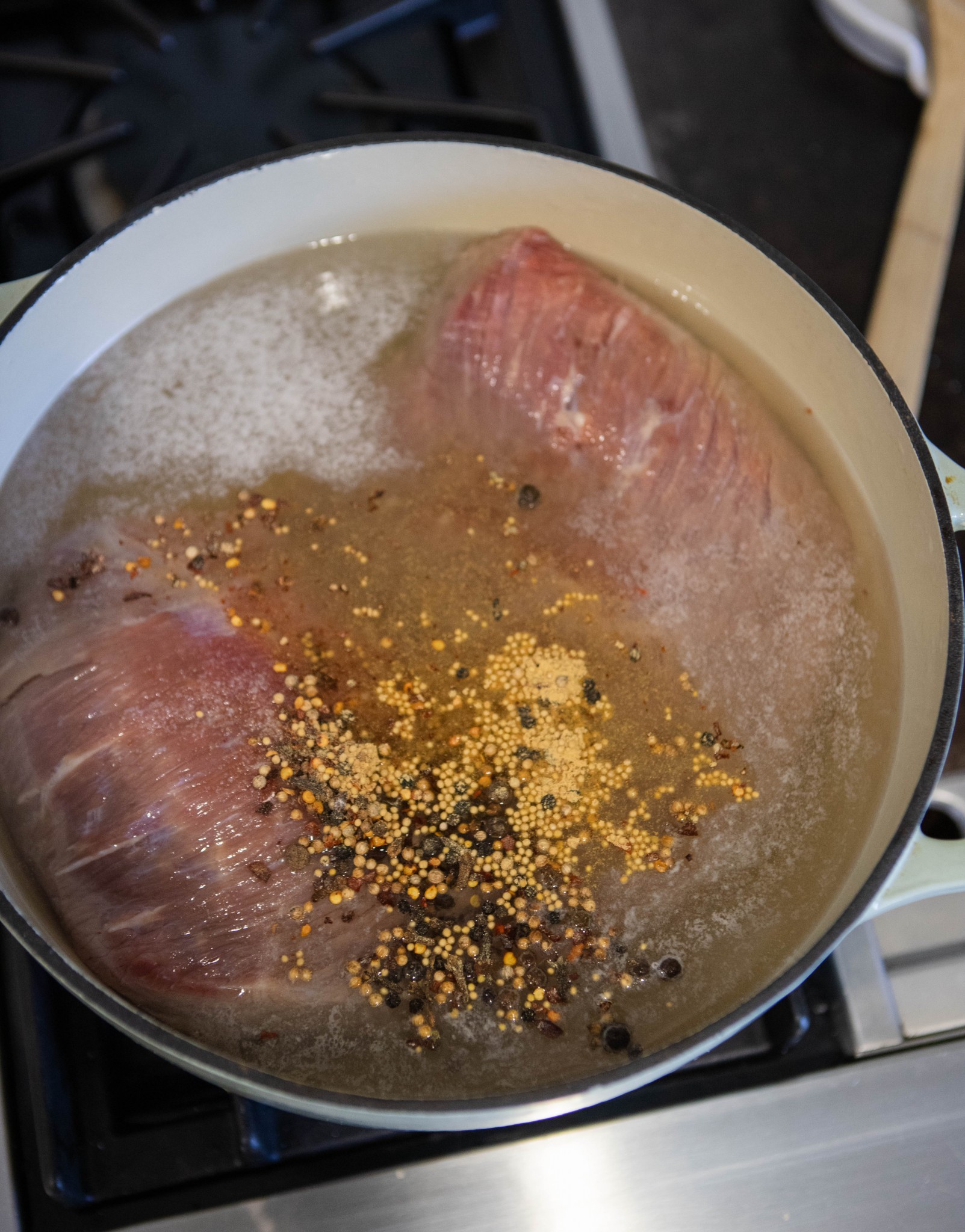 beef brisket simmering in water to make corned beef