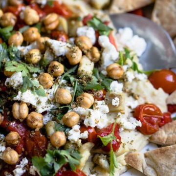 hummus dip loaded with crunchy chickpeas, feta cheese, roasted tomatoes