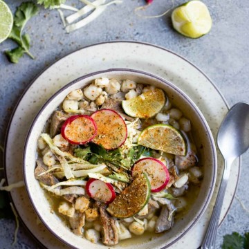 New Mexico posole in a beige bowl with garnishes