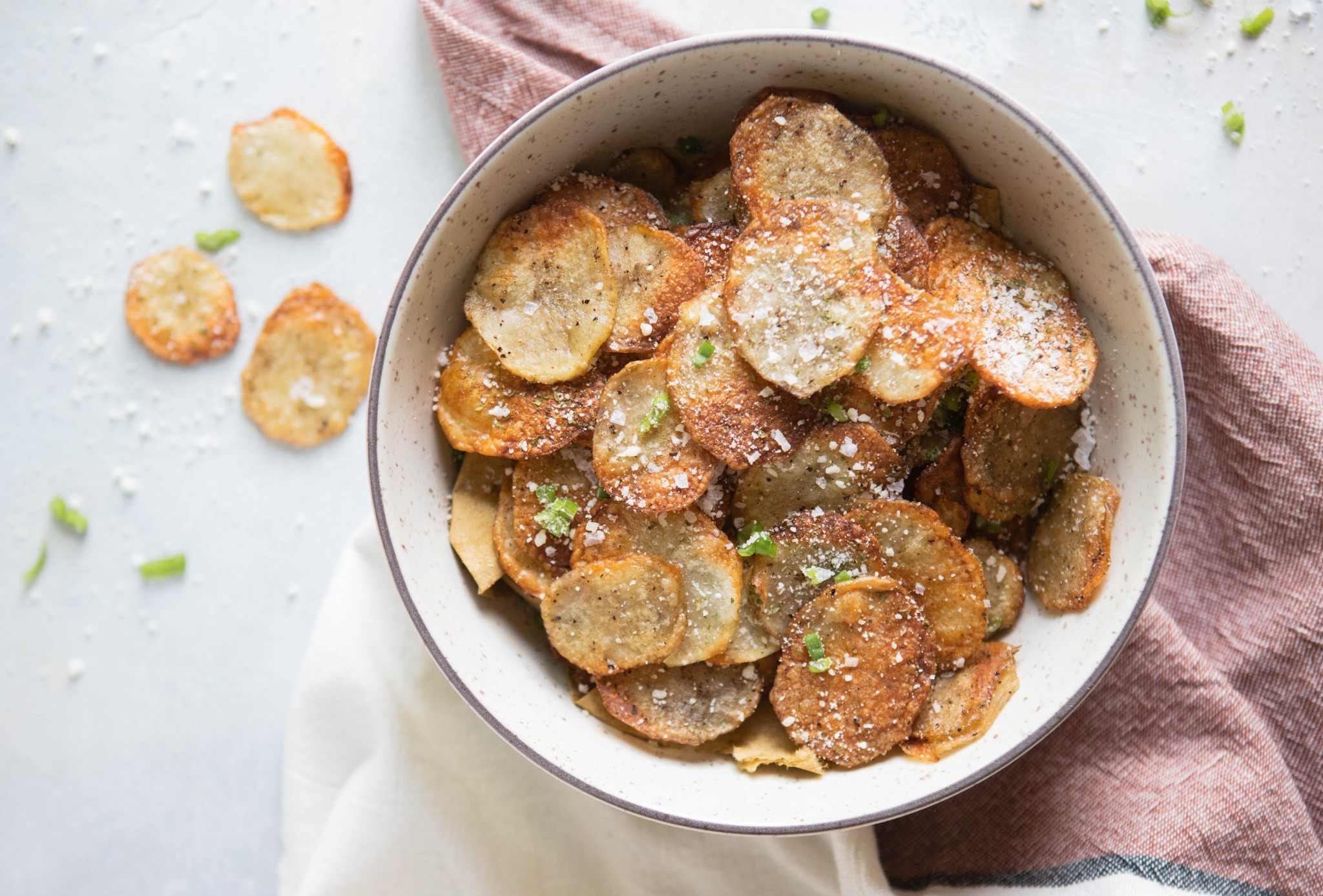 truffle potato chips in a beige bowl against a white backdrop