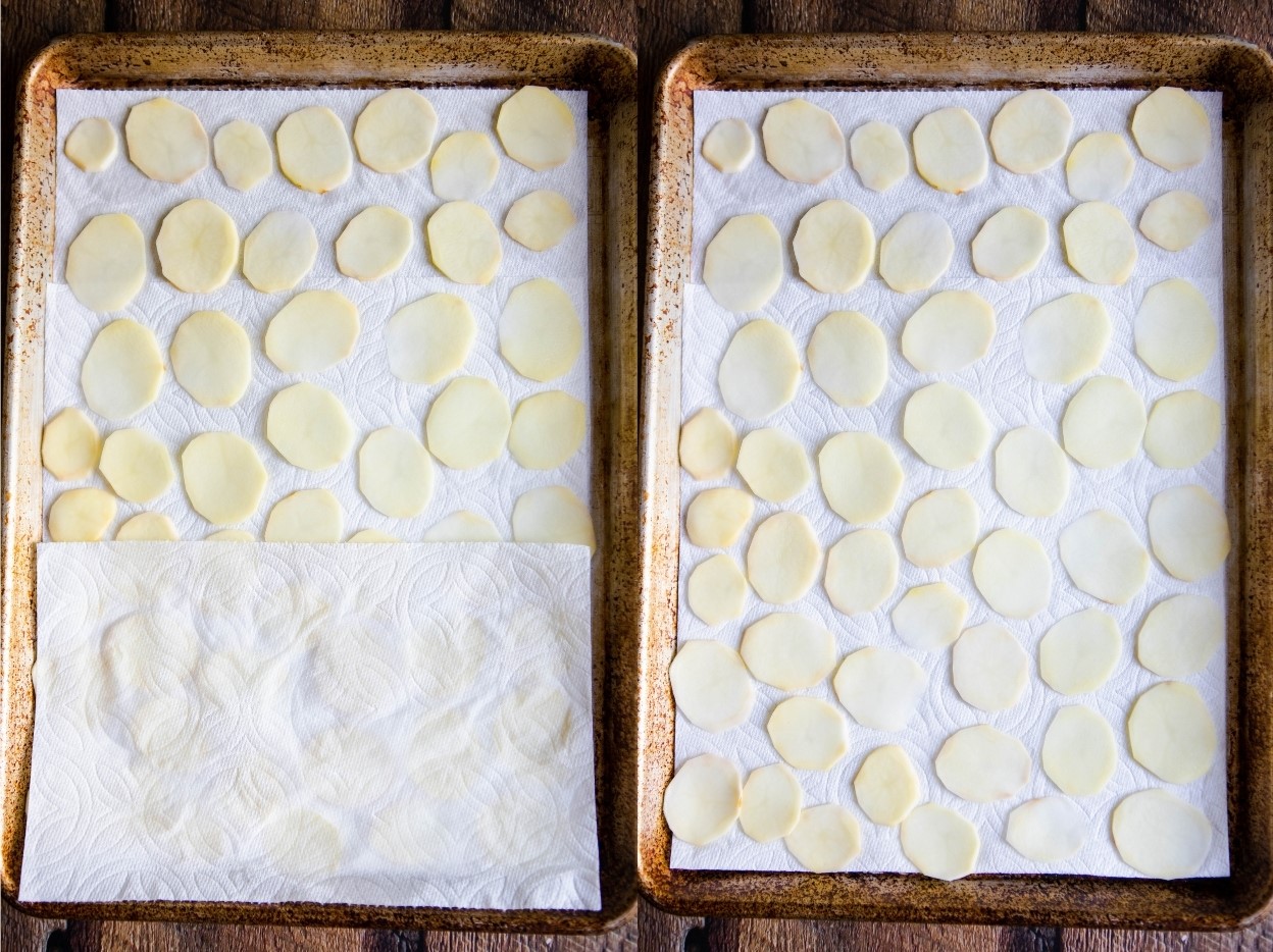 sliced potatoes laid out on a paper towel lined baking sheet