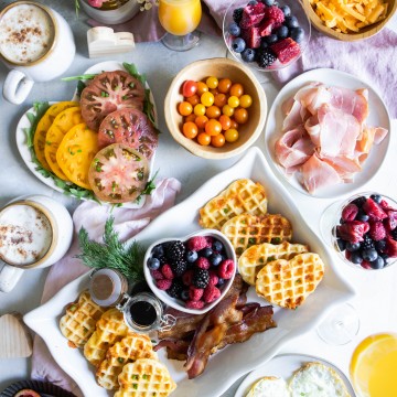 heart waffles and various snack and food items for a Valentine's Day breakfast