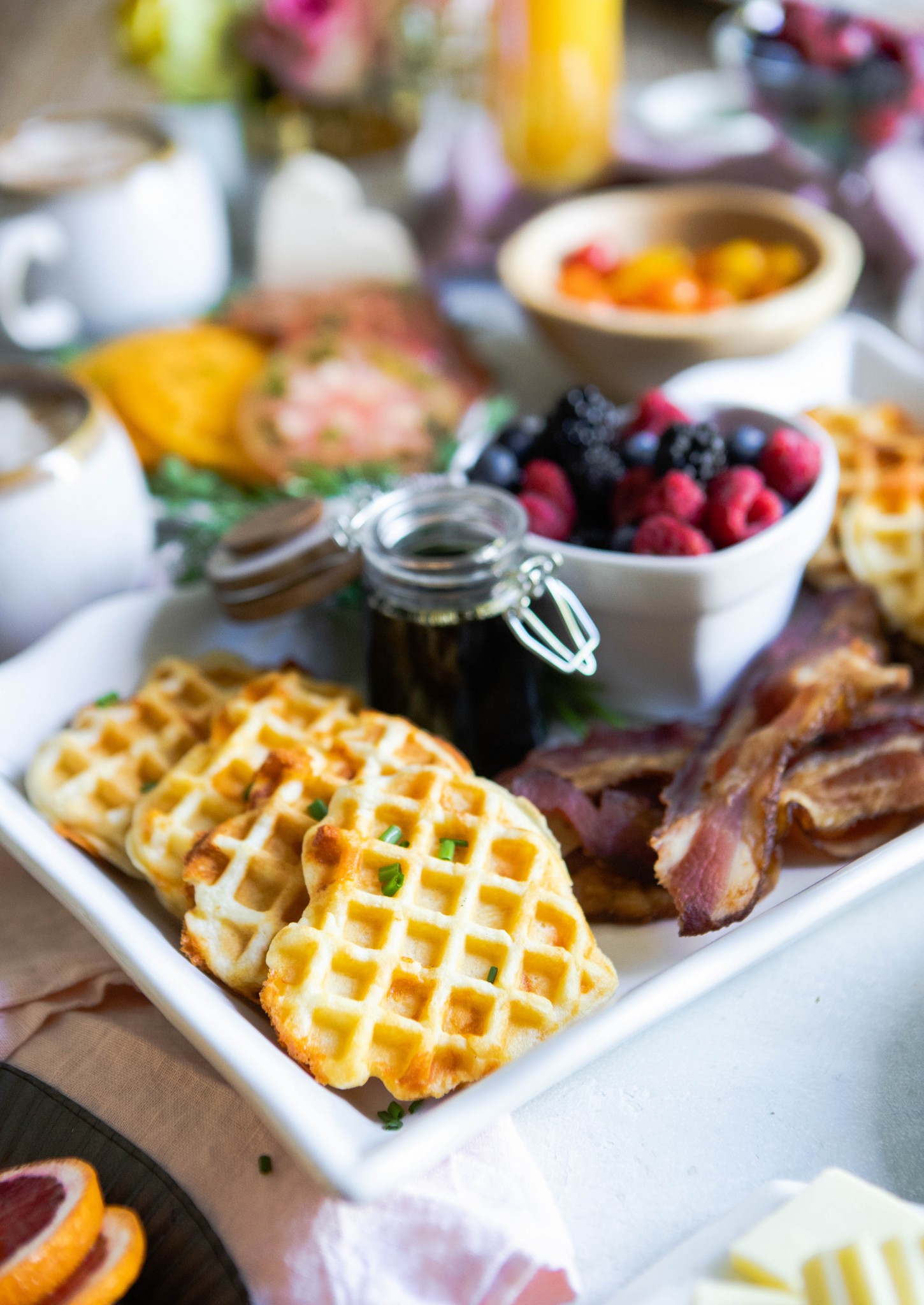 heart waffles next to bacon and berries