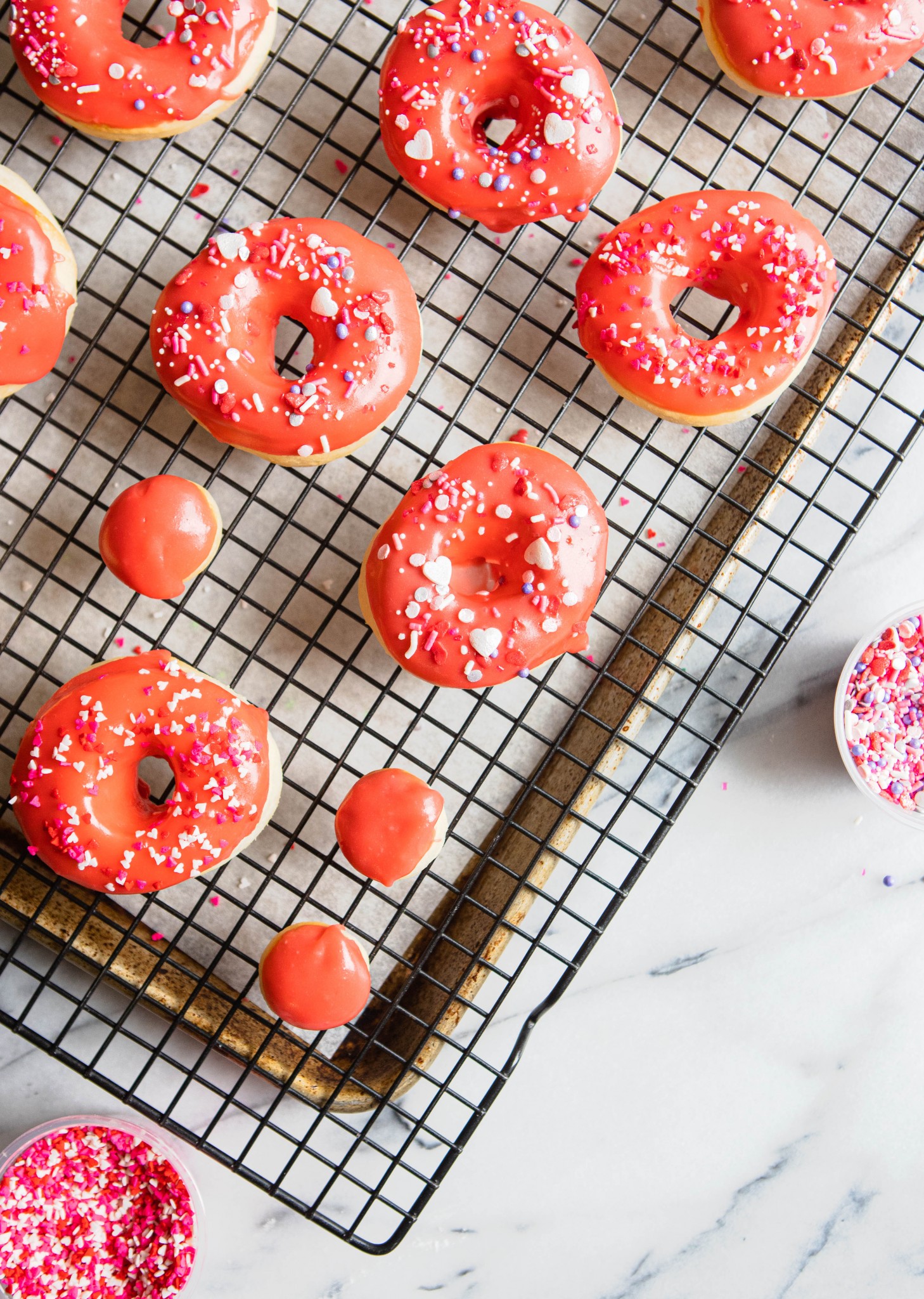 red glazed donuts on a cooling rack