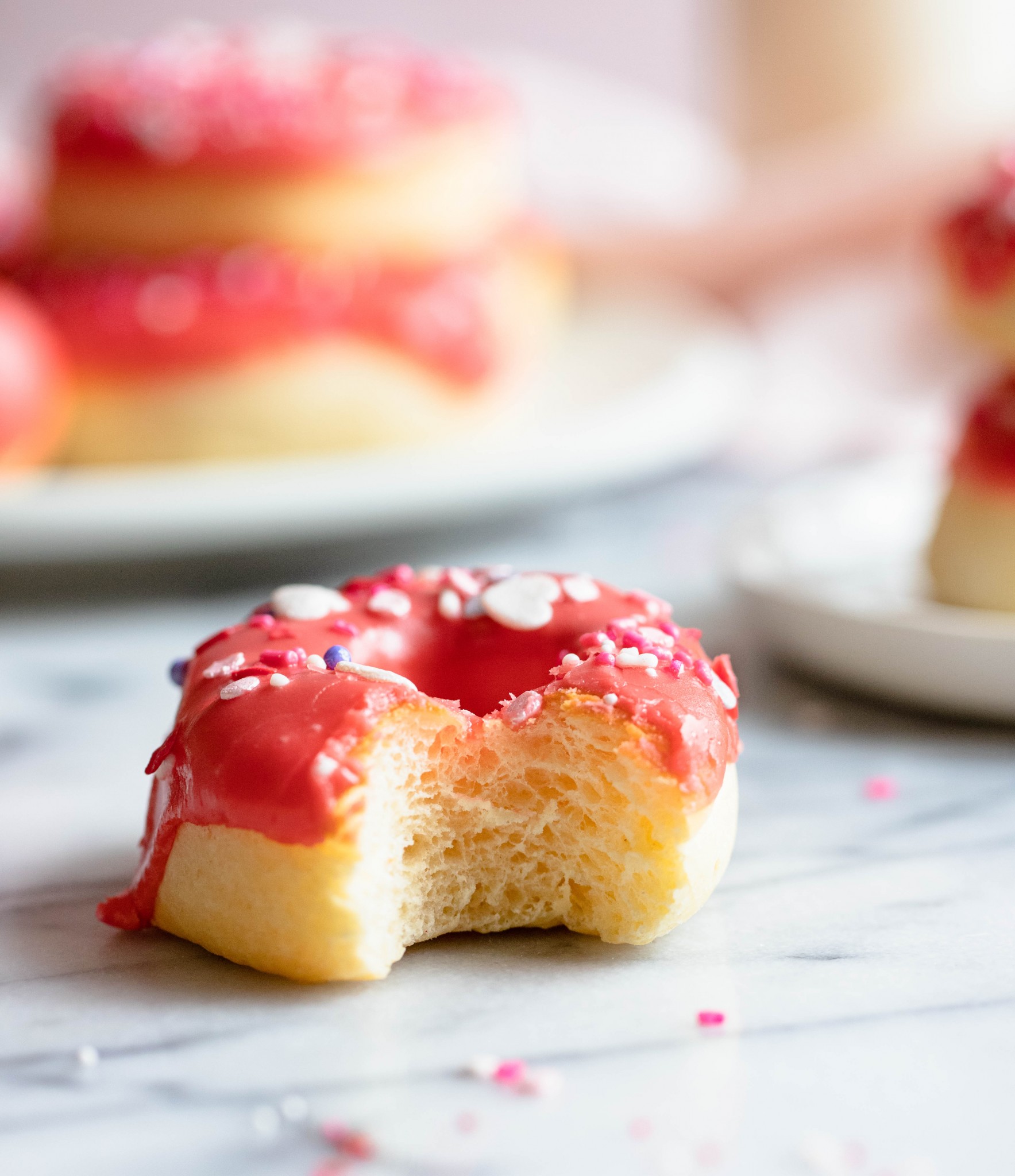 close up of bitten into glazed donut