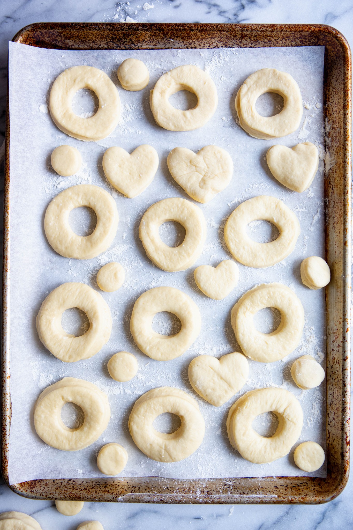 cut out donuts on a cookie sheet lined with parchment paper