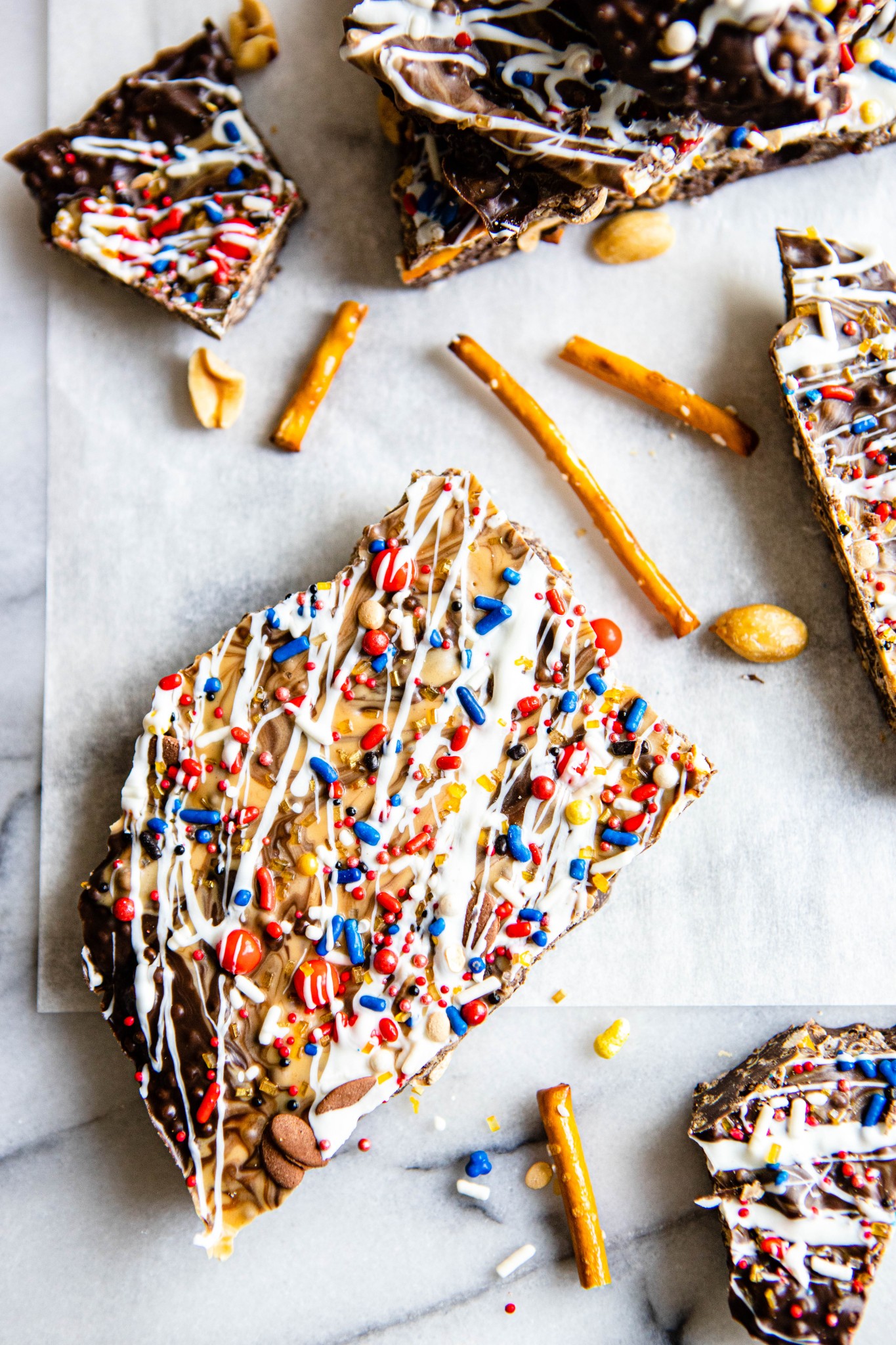 close up of a piece of dark chocolate bark with peanut butter and pretzels