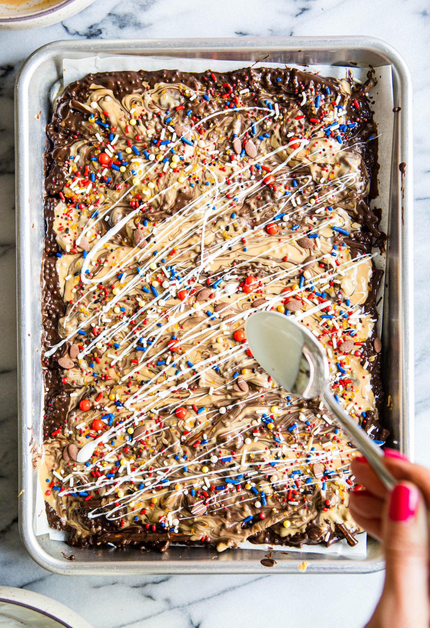white chocolate drizzled on a tray of dark chocolate bark for a fun Super Bowl dessert ideas 
