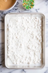 white chocolate bark spread out on a sheet pan