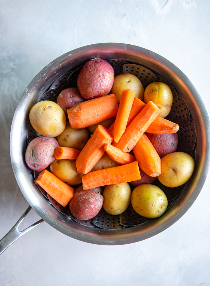 carrots and potatoes in a medium sized stock pan