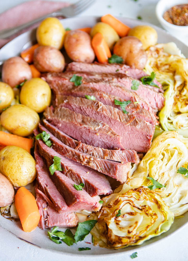 homemade corned beef with braised cabbage and potatoes on a platter