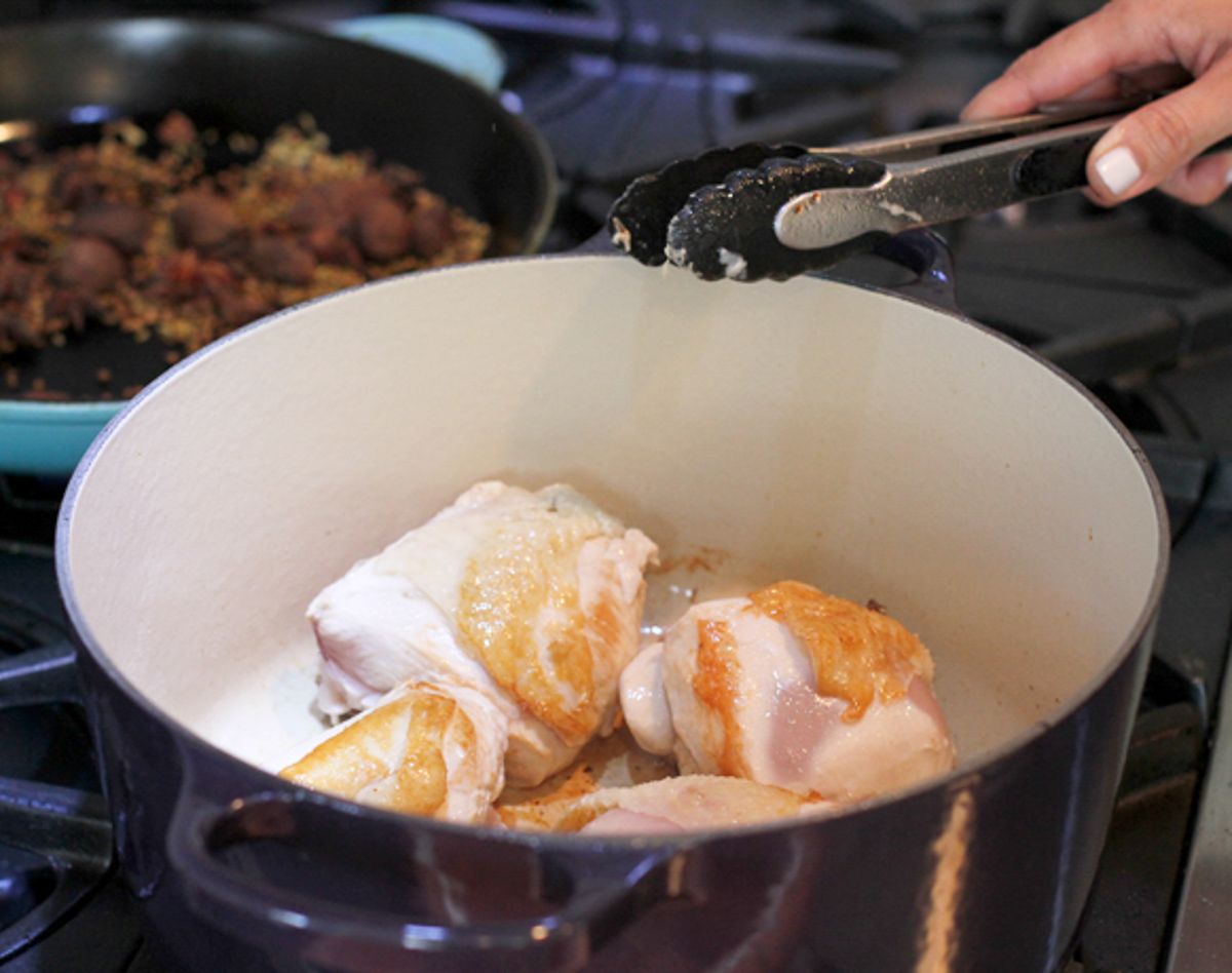 bone-in skin on chicken pieces browning in a Dutch oven 