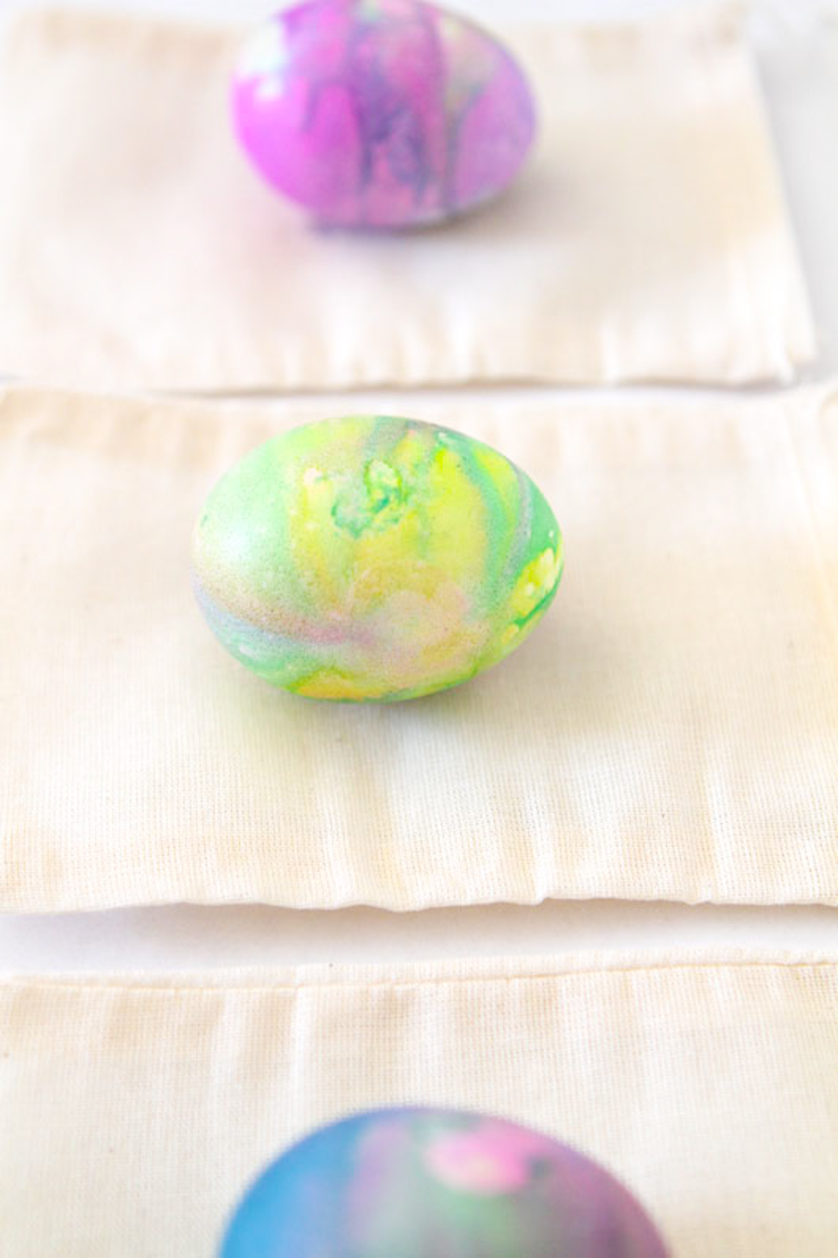 marbled watercolor Easter eggs set on cotton bags