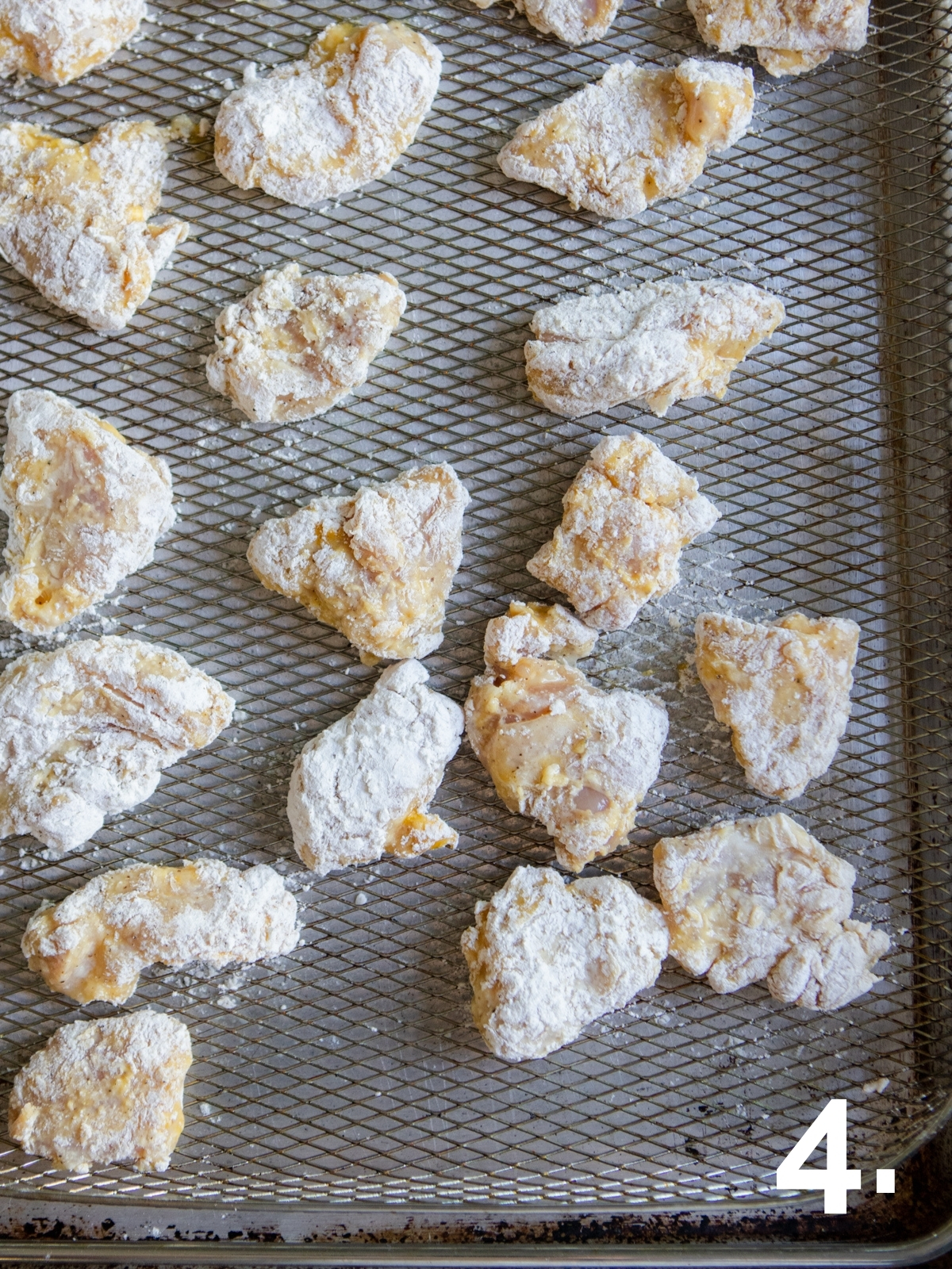 breaded chicken pieces set on air fryer rack