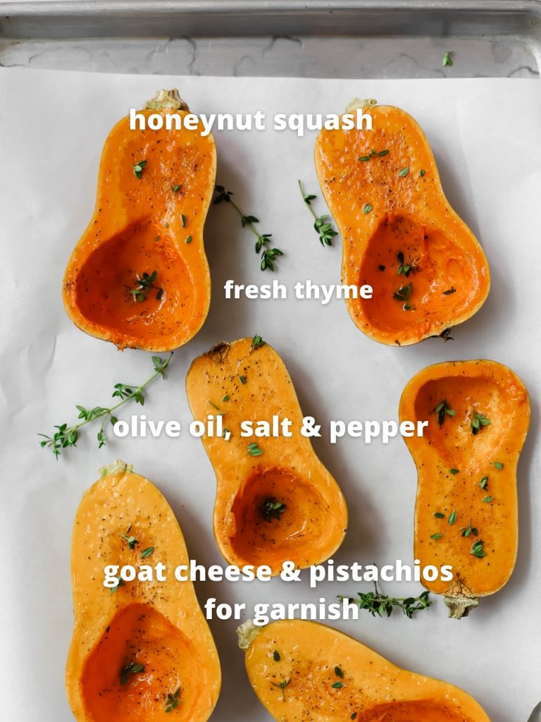 uncooked honeynut squash cut in half and sprinkled with salt and pepper and thyme on a baking sheet