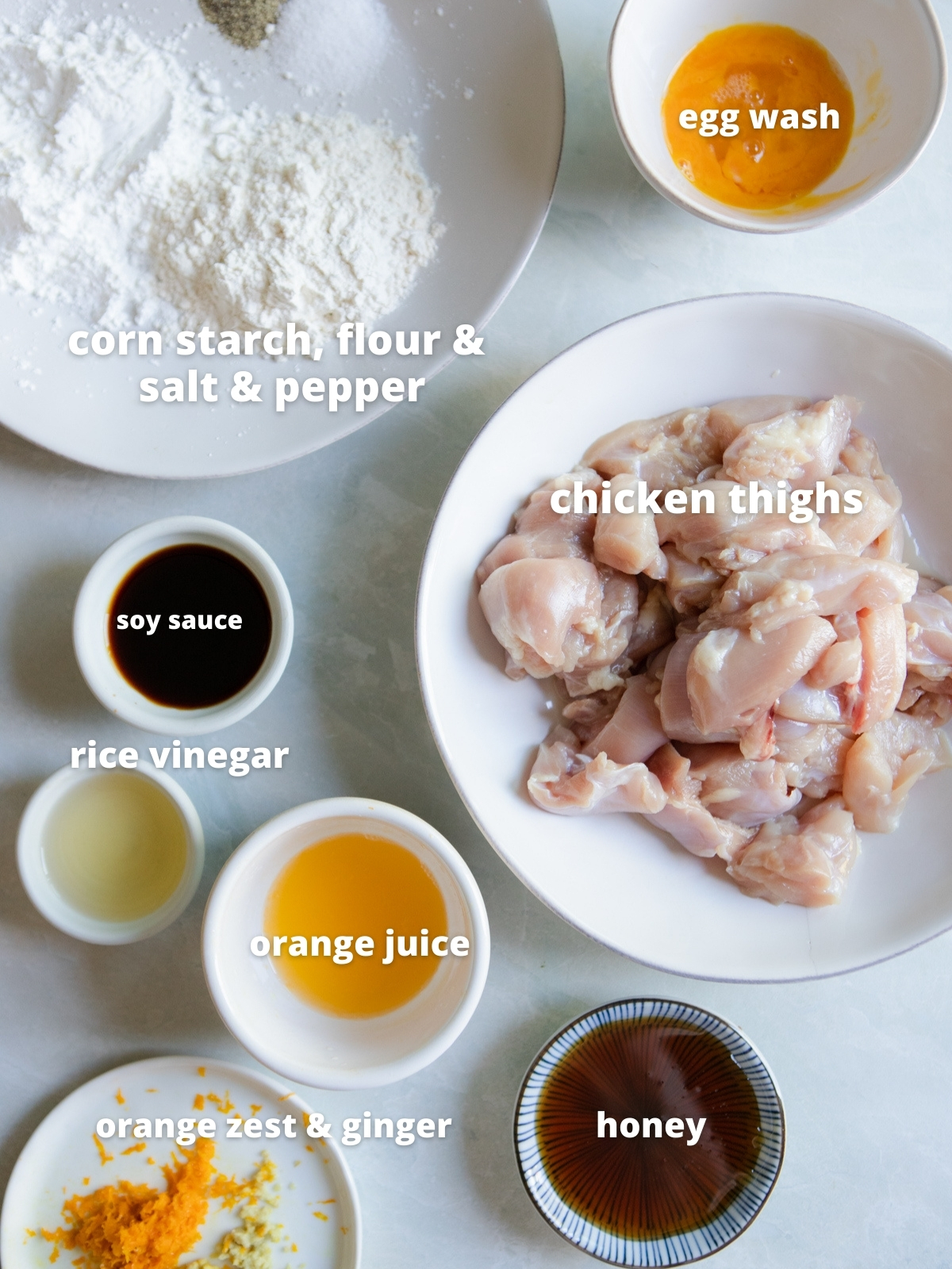 raw ingredients in shallow white bowls for trader joe's orange chicken air fryer recipe 