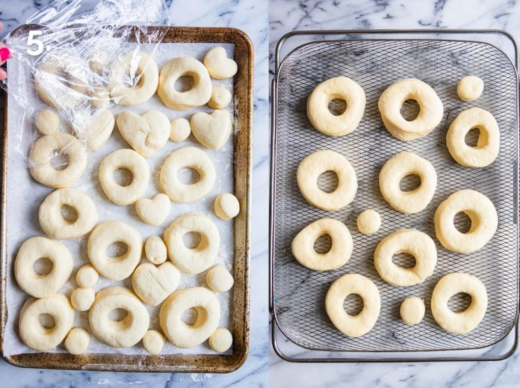 air fryer donuts rising on a sheet pan
