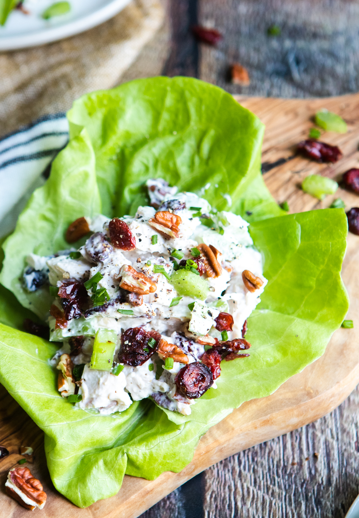 piece of butter lettuce with a scoop of cranberry pecan chicken salad on top