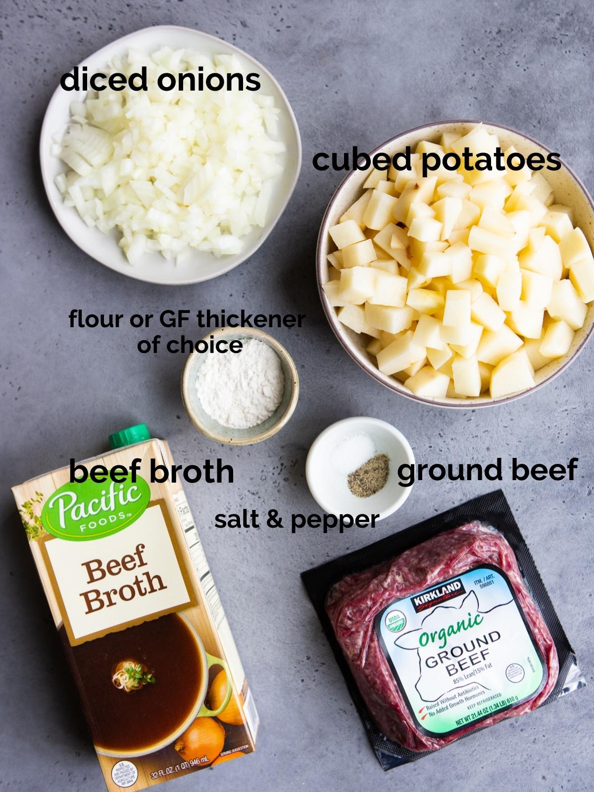 hamburger potato soup ingredients on a gray table