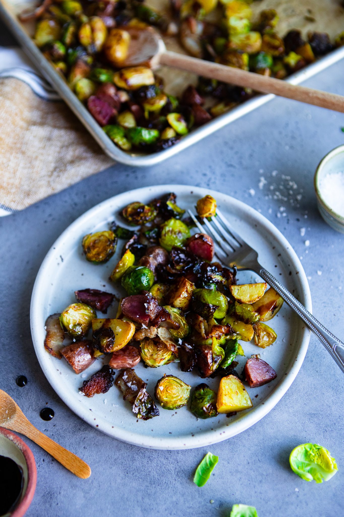 plated air fried brussels sprouts with potatoes and bacon and tossed in balsamic glaze
