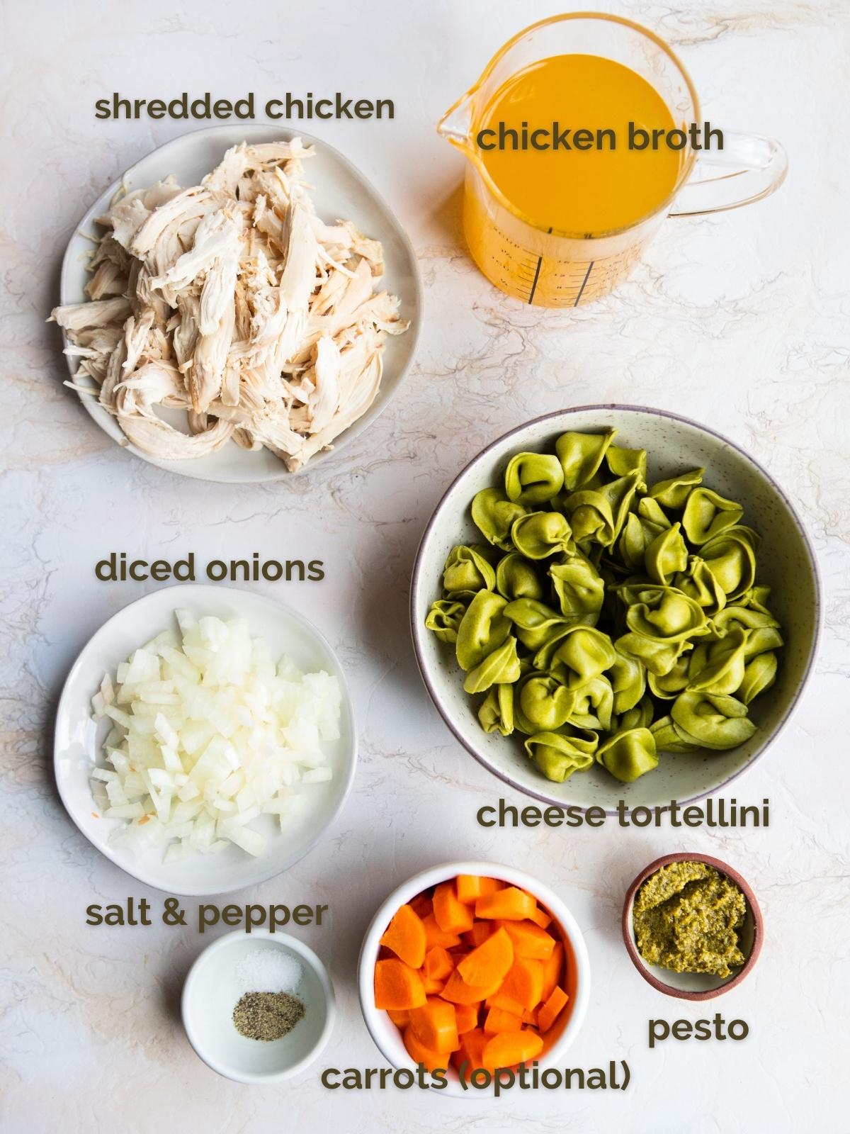 raw ingredients to make chicken cheese tortellini soup in white bowls 