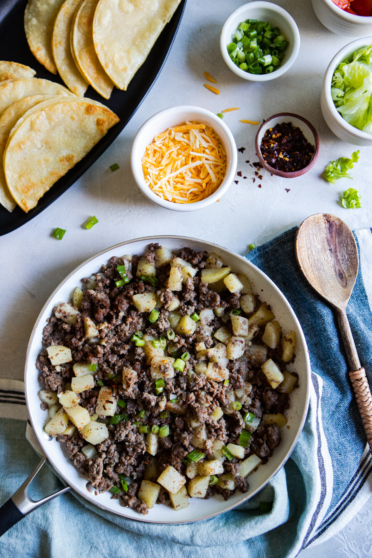 skillet filled with taco filling of ground beef and potatoes