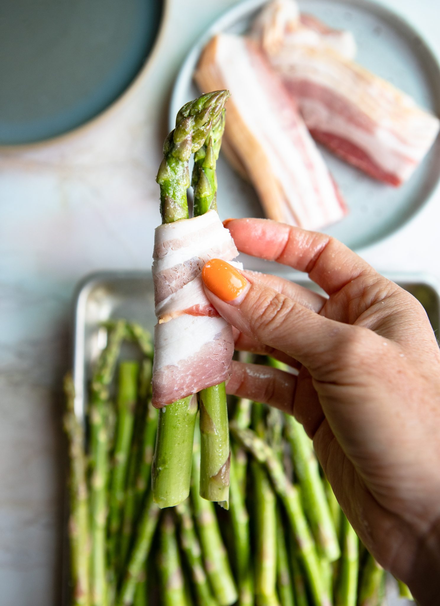 raw bacon wrapped around uncooked asparagus