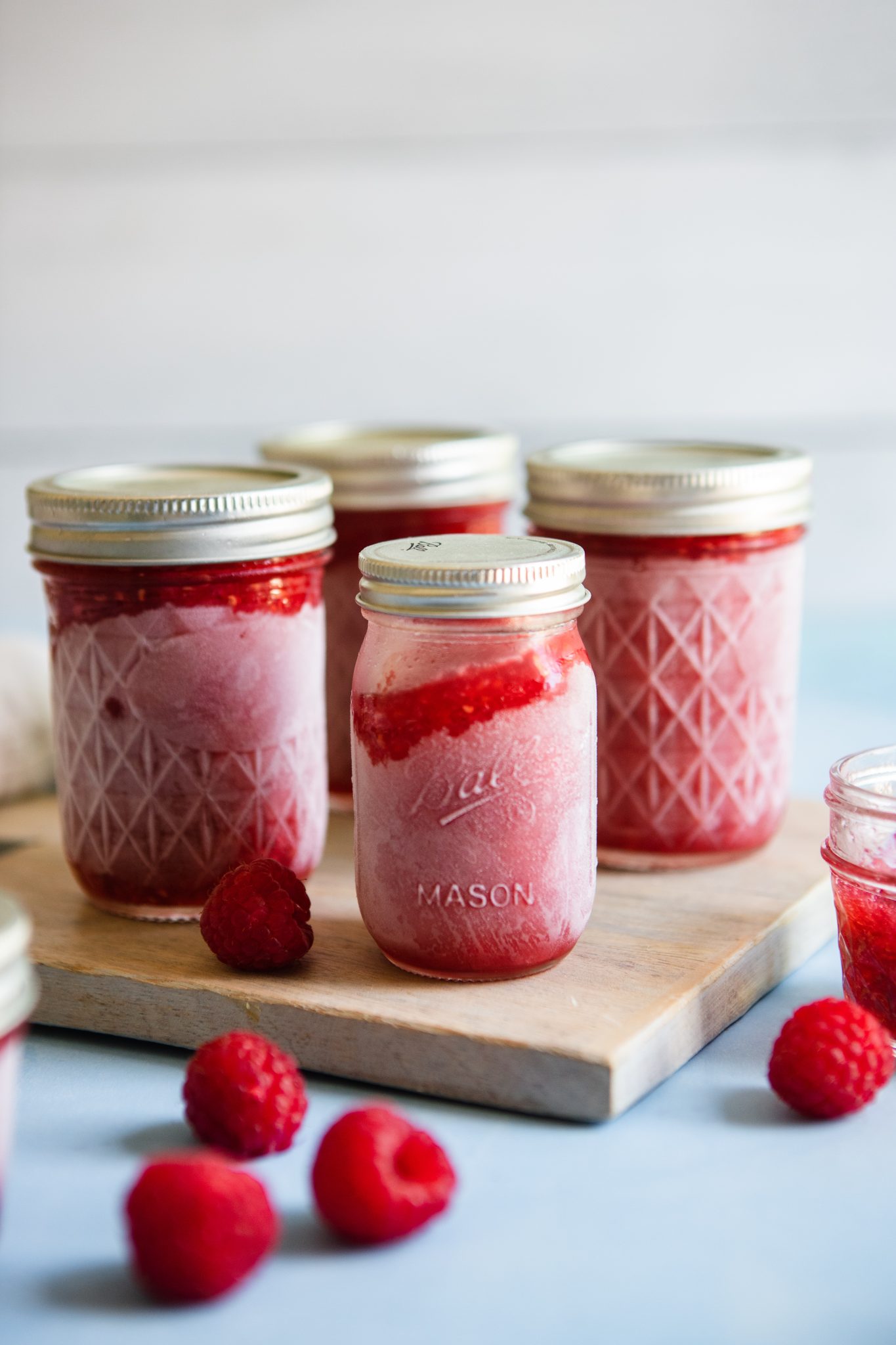 mason jars filled with raspberry freezer jam