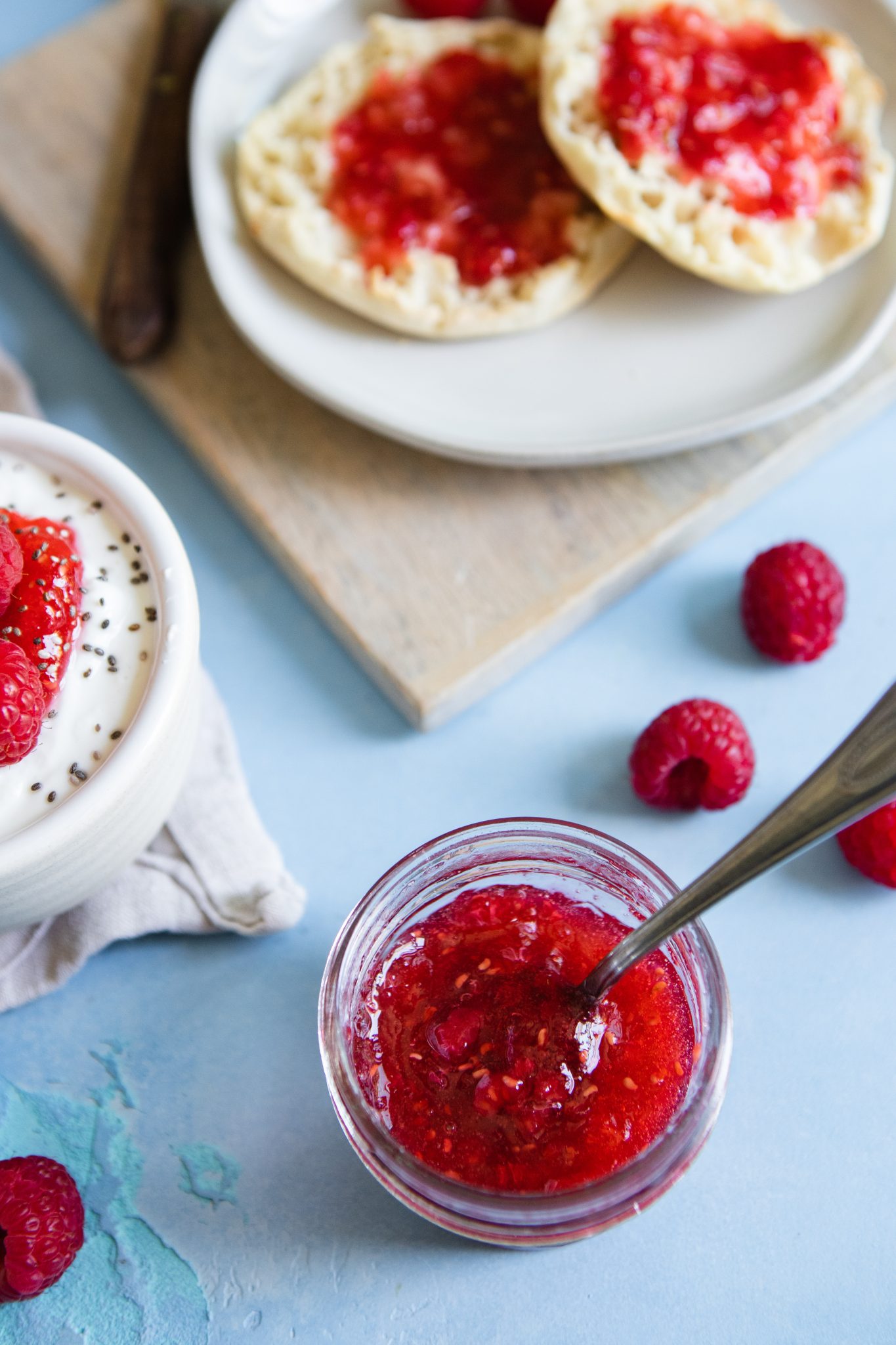 raspberry freezer jam recipe distributed in small mason jars 