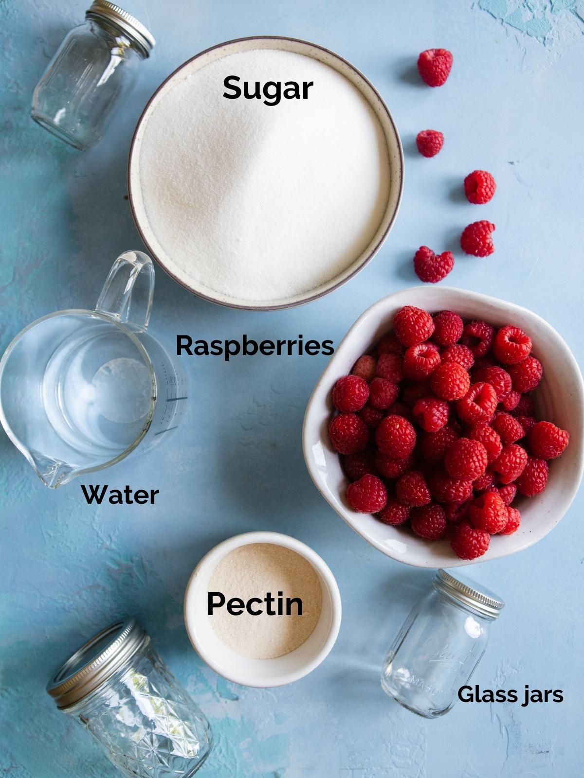 raw ingredients in white bowls to make raspberry freezer jam recipe 