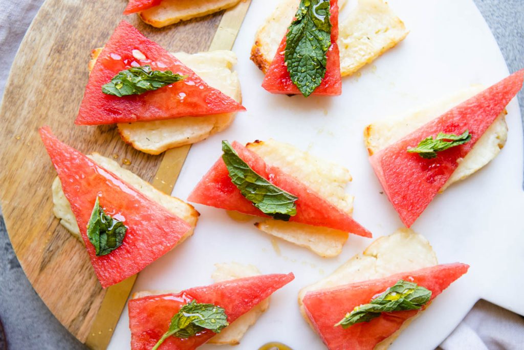 air fried halloumi cheese slices garnished with mint and watermelon slices 