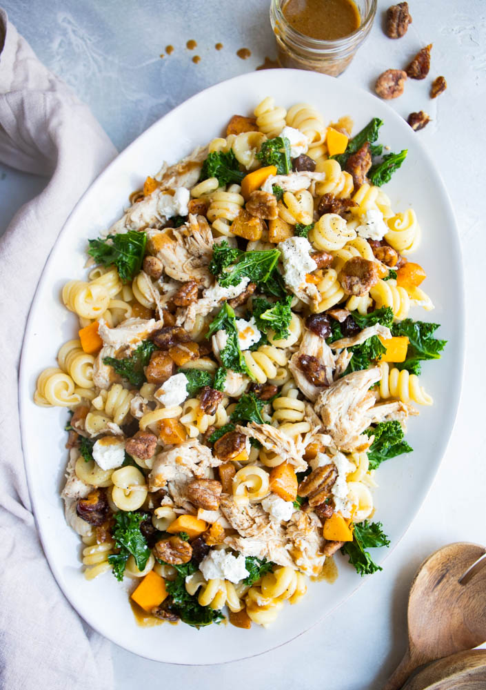 fall pasta salad drizzled with balsamic vinaigrette dressing on a gray table