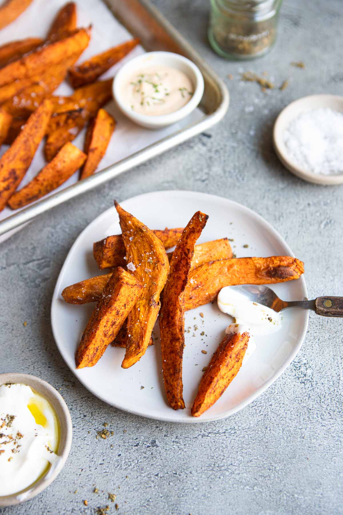 air fryer sweet potato wedges on a white plate served with dipping sauce