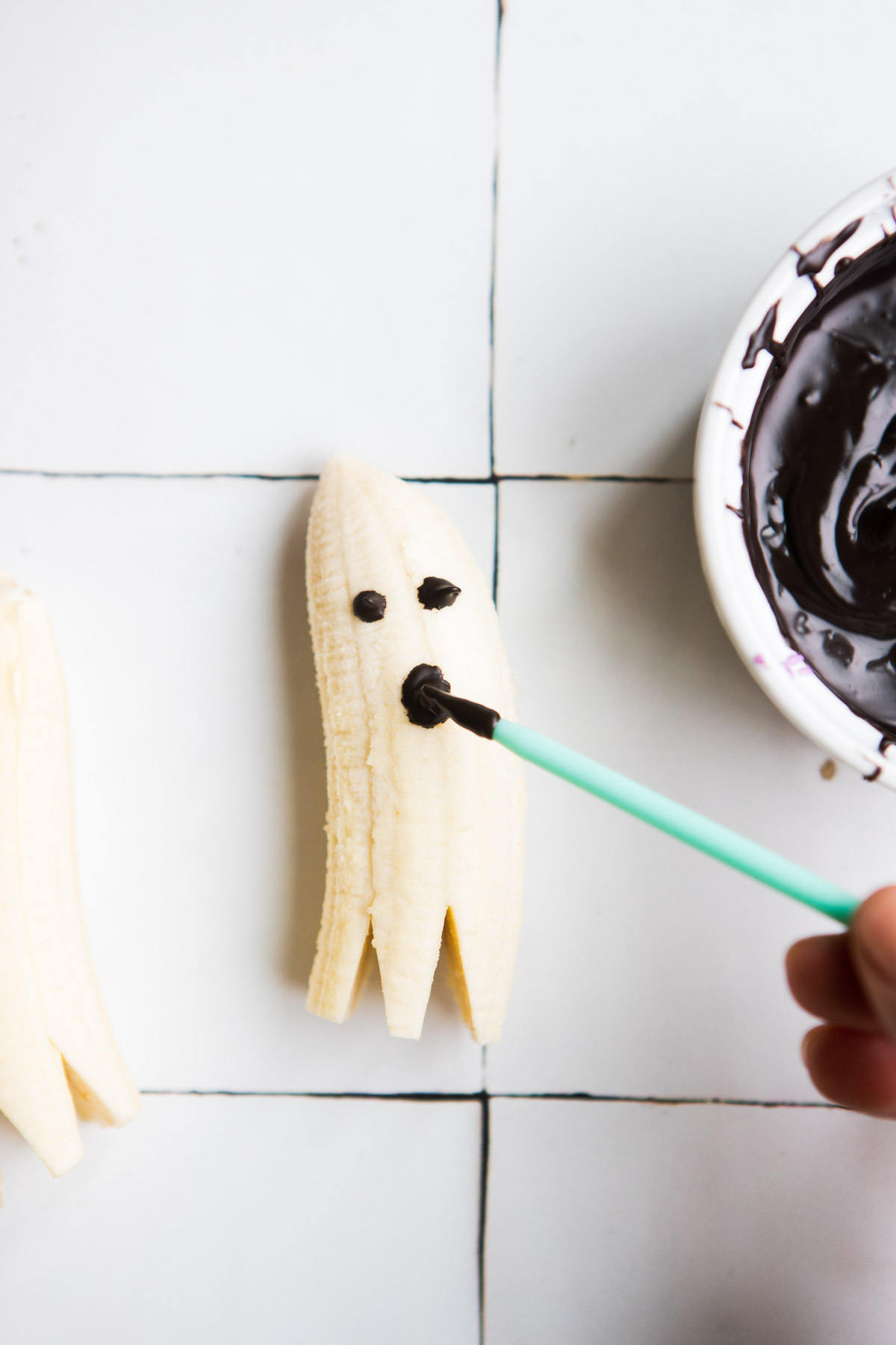 dark chocolate being drawn onto a banana