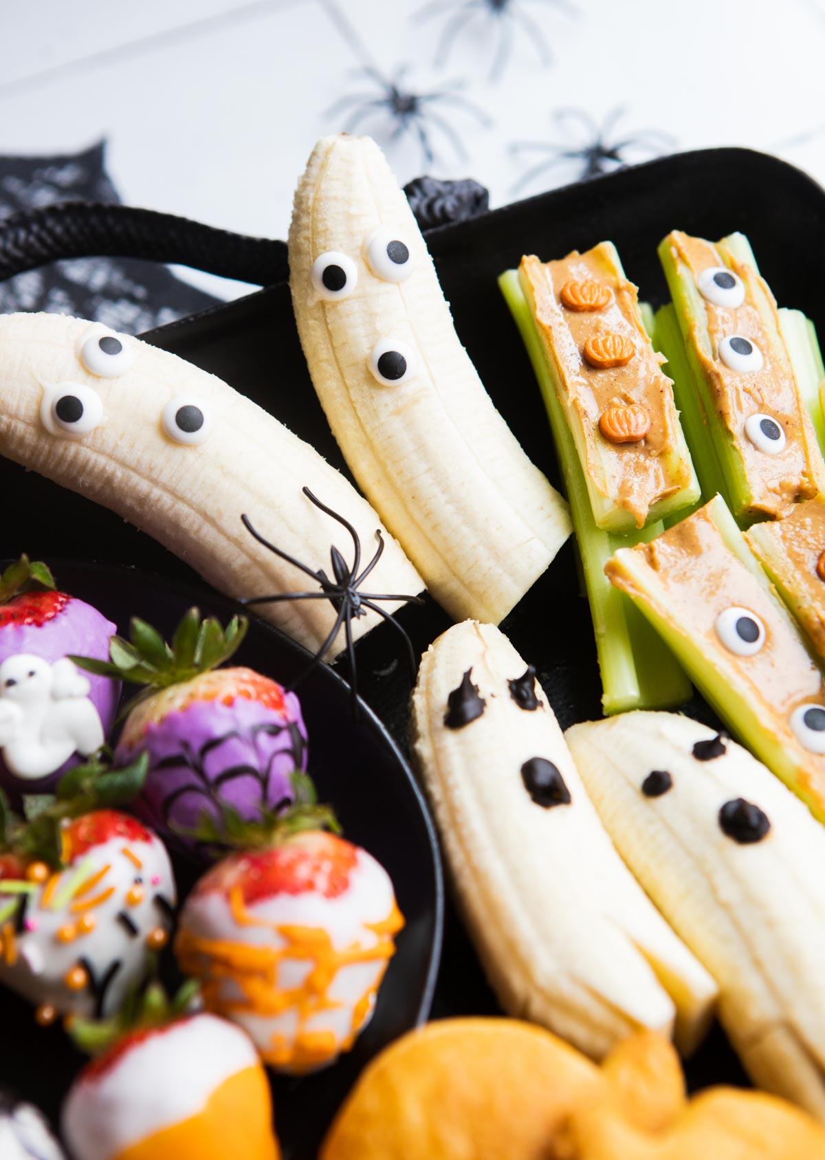 halloween themed snacks on a black metal tray