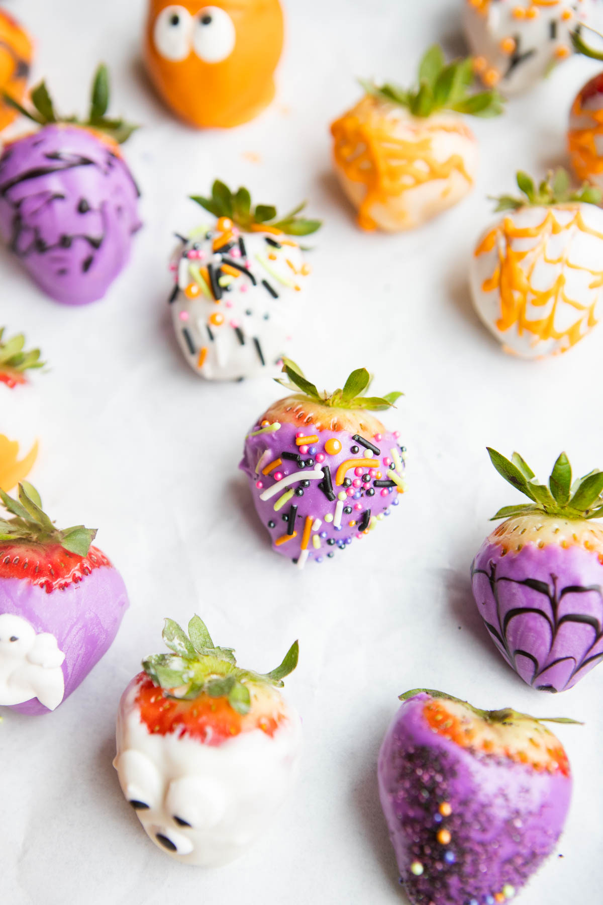 purple chocolate covered strawberry decorated with Halloween sprinkles 