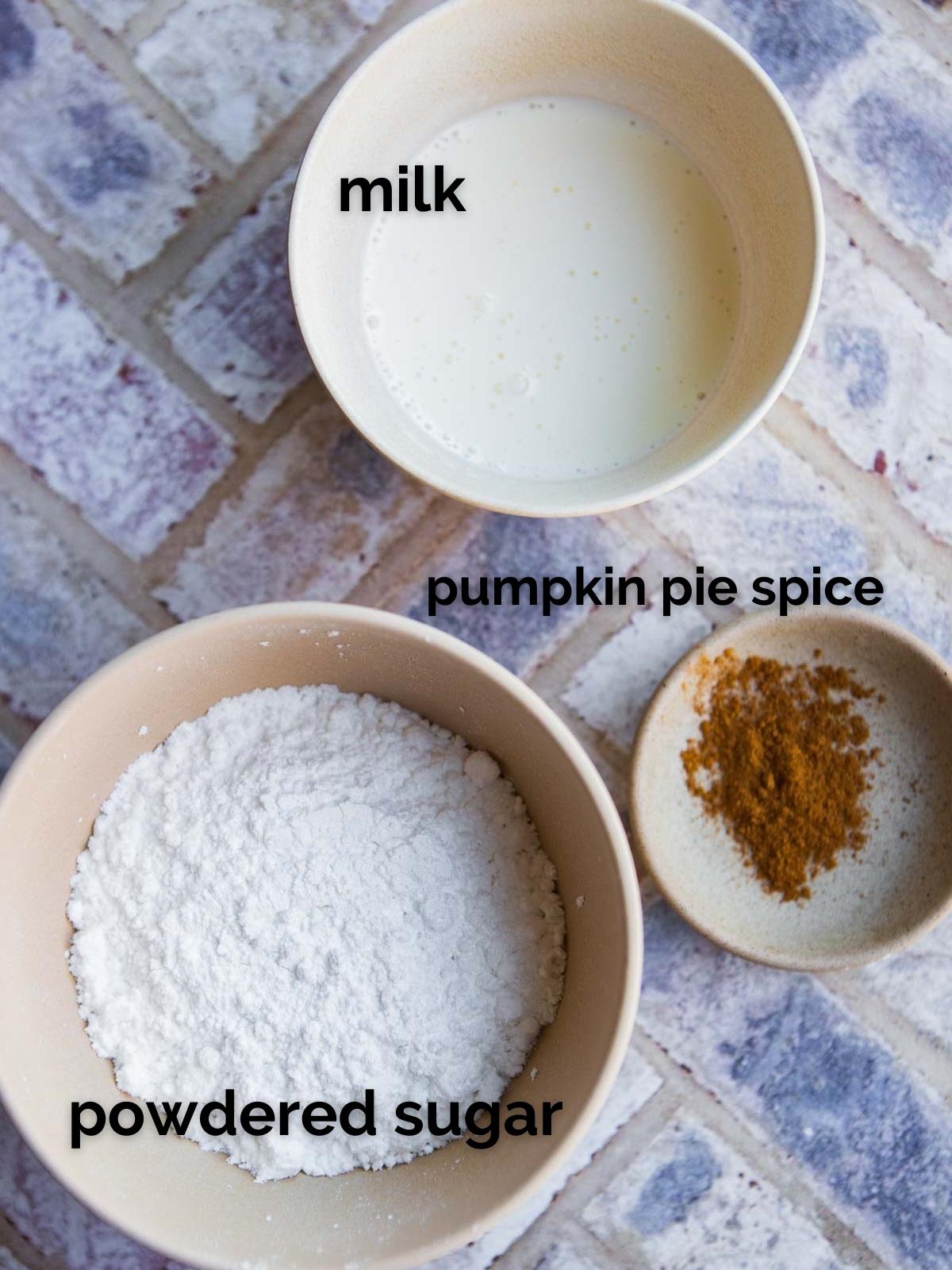 3 bowls each filled with pumpkin pie spice, powdered sugar and milk 
