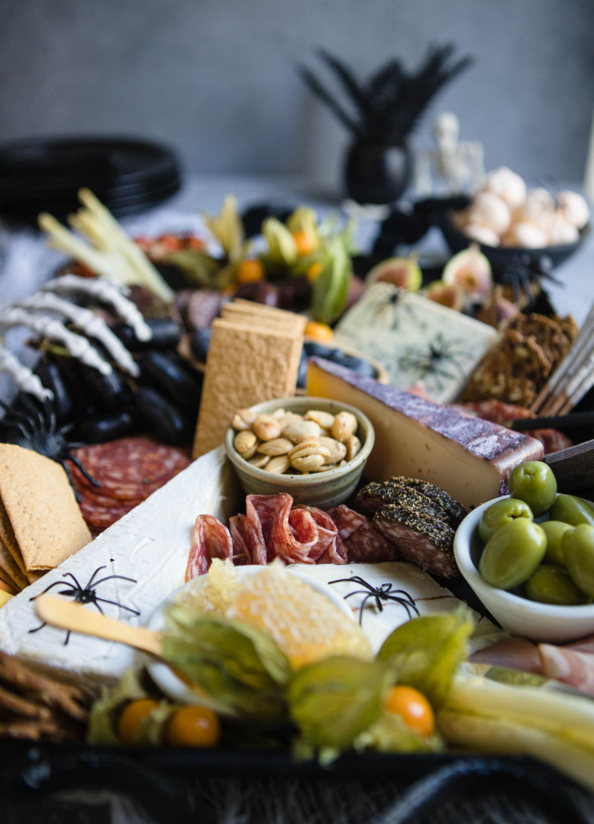 charcuterie board filled with seasonal fruits and cheeses 